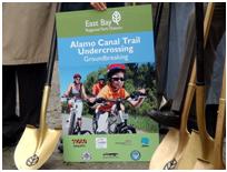 picture of alamo canal trail brochure in between two shovels