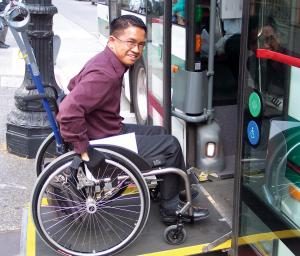 man in wheelchair boarding bus