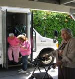 woman getting out of paratransit van