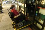 woman with wheelchair boarding a bus