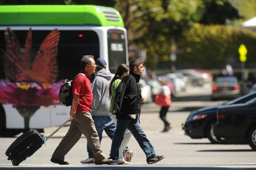 Modes of travel - people walking, bus, car