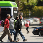 Modes of travel - people walking, bus, car