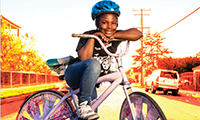 Active Transportation button with girl leaning on bicycle